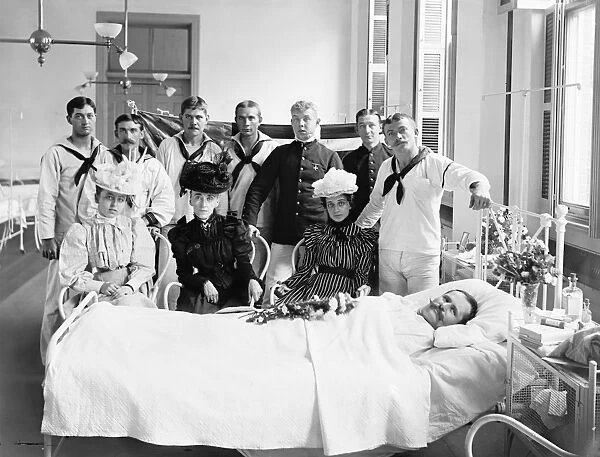 BROOKLYN: HOSPITAL, c1900. Sailors and women visiting a patient at the Brooklyn