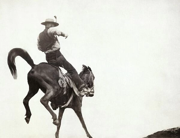 BUCKING BRONCO, c1888. Ned Coy, a cowboy from South Dakota riding his bucking horse named Boy Dick. Photograph by John C. H. Grabill, c1888