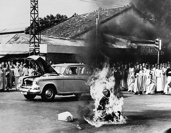 Buddhist monk Thich Quang Duc (1897-1963) committing self-immolation at an intersection in Saigon, South Vietnam, in protest against the anti-Buddhist measures of President Ngo Dinh Diem and his treatment of protestors, 11 June 1963. Photographed by Malcolm Browne
