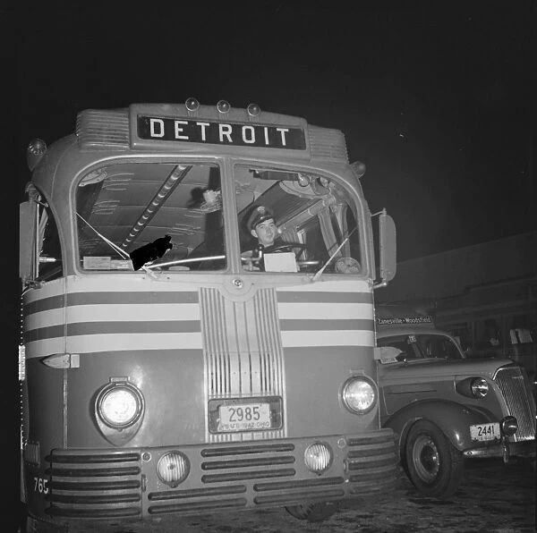 BUS DRIVER, 1943. Lester Ward, a Greyhound bus driver, taking the bus out of the