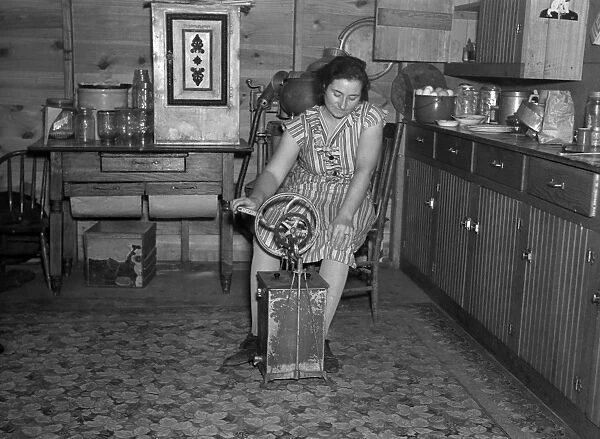 BUTTER CHURN, 1936. Farmers wife churning butter, Emmet County, Iowa. Photograph by Russell Lee