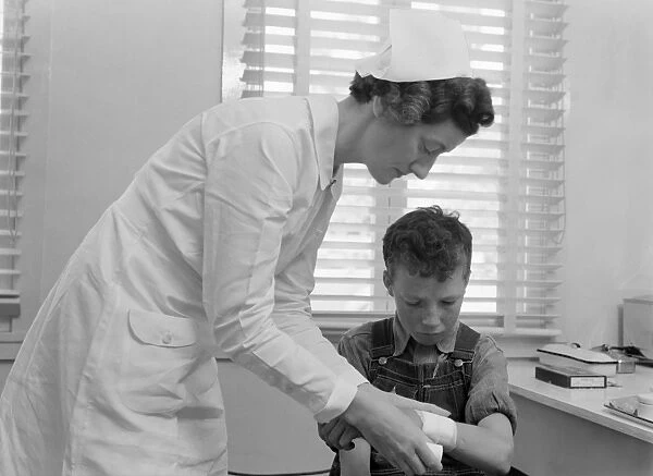 CALIFORNIA: HEALTH CLINIC. A boy receiving medical attention at a health clinic