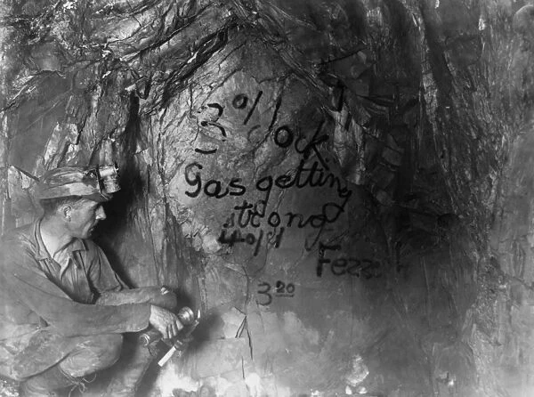CALIFORNIA: MINING, c1922. A miner looking at the last message left by 47 entombed