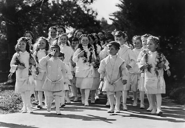 CALIFORNIA: POINT LOMA, 1919. A group of children draped in garlands of flowers