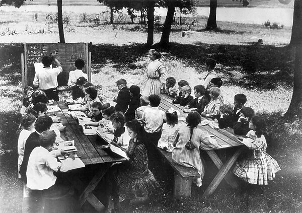 CAMP ALGONQUIN: MATH CLASS. An open-air school at Camp Algonquin with two boys