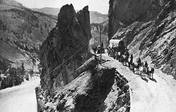 CANADA: CARIBOO ROAD, 1868. A wagon train traveling along the Cariboo Road through