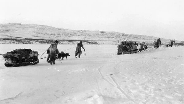 CANADA: ESKIMOS. A group of Eskimos with their dogsleds on their way to the sea, Canada