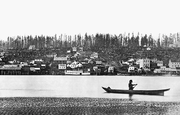 CANADA: NEW WESTMINSTER. A Native American paddles past the frontier city of New Westminster