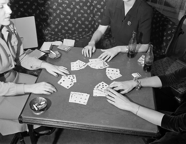 CARD GAME, 1941. Women playing cards and drinking Coca-Cola in Detroit, Michigan