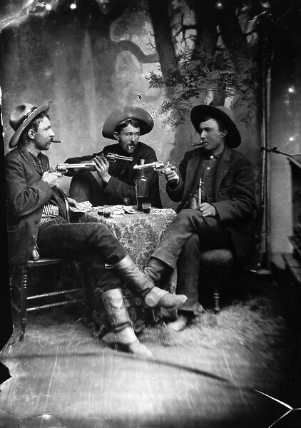 CARD PLAYERS, c1870. Three gunslingers in the American West playing cards. Tintype