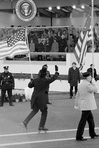 CARTER INAUGURATION, 1977. A flag-waving roller skater in a tuxedo passing by the reviewing stand during the inauguration parade for President Jimmy Carter, 20 January 1977. Photograph by Marion Trikosko