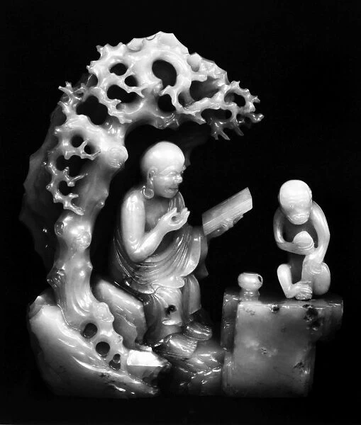 Carved jade figure of a lohan and a monkey in a grotto. Ching Dynasty, late 17th century