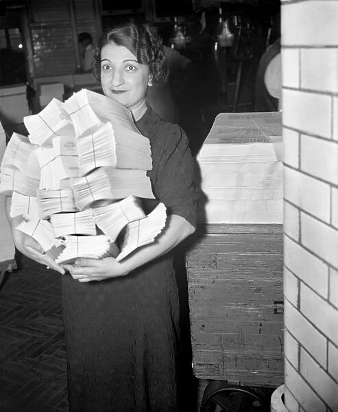 CENSUS CARDS, 1937. A staff member of the Government Printing Office carrying a
