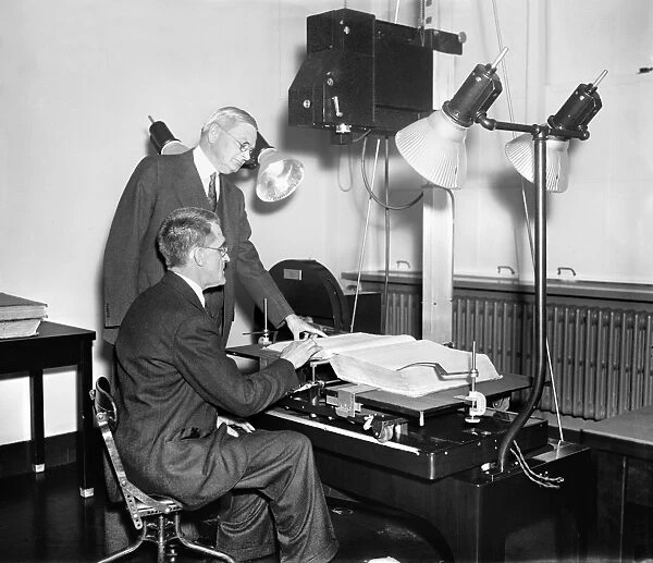 CENSUS RECORDING, 1937. A member of the Social Security board photographing Census