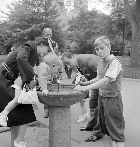 CENTRAL PARK, 1942. A family at the drinking fountain in Central Park in New York City