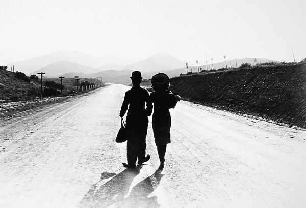 CHAPLIN: MODERN TIMES, 1936. Charlie Chaplin and Paulette Goddard in the final scene from the film, Modern Times, 1936
