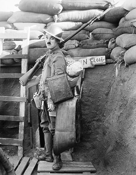 CHAPLIN: SHOULDER ARMS. Charlie Chaplin, English actor and comedian, in a scene from Shoulder Arms, 1918