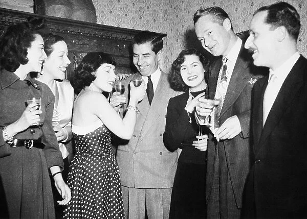 CHARLES LUCKY LUCIANO (1897-1962). American gangster. Luciano (center) at a party in Rome, 1949