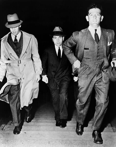 CHARLES LUCKY LUCIANO (1897-1962). American (Italian-born) gangster. Being escorted into court