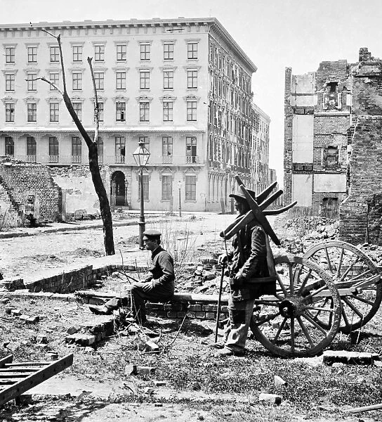 CHARLESTON RUINS, 1865. Two men amongst the ruins of Charleston, South Carolina with the Mills House in the background. Photograph by George Barnard, April 1865