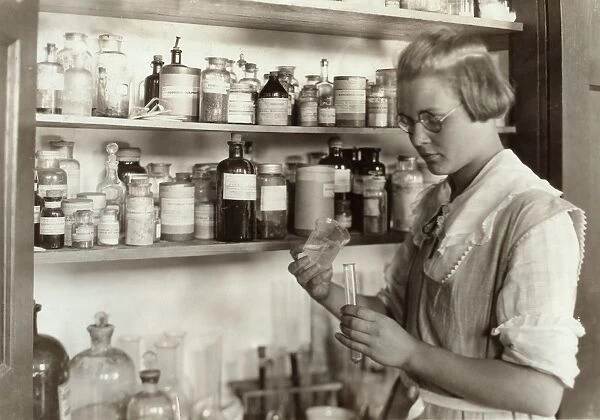 CHEMISTRY CLASS, 1921. A high school student in the chemical laboratory at the