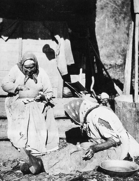 CHEROKEE POTTERS, 1888. A Cherokee mother and her adult daughter making pots of