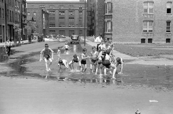 CHICAGO, 1941. Boys playing the the water from a fire hydrant in Chicago, Illinois