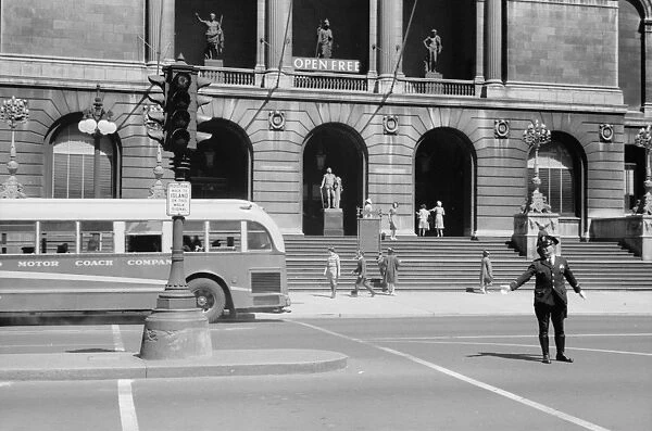 CHICAGO: ART INSTITUTE, 1940. A police officer directing traffic outside the Art