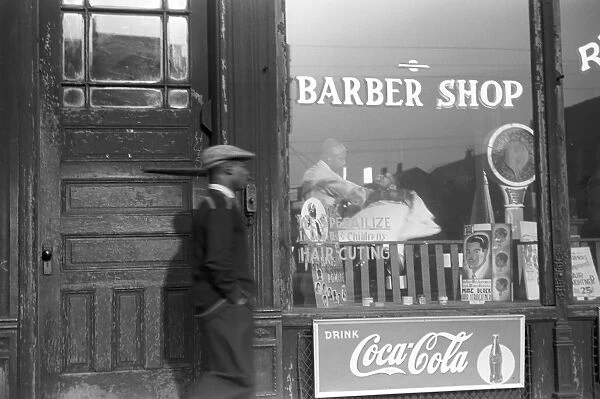 CHICAGO: BARBER SHOP, 1941. A barbershop in the Black Belt section of Chicago, Illinois. Photograph by Edwin Rosskam, April 1941