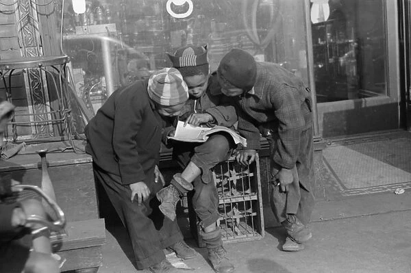CHICAGO: CHILDREN, 1941. African American children reading a comic book together in Chicago