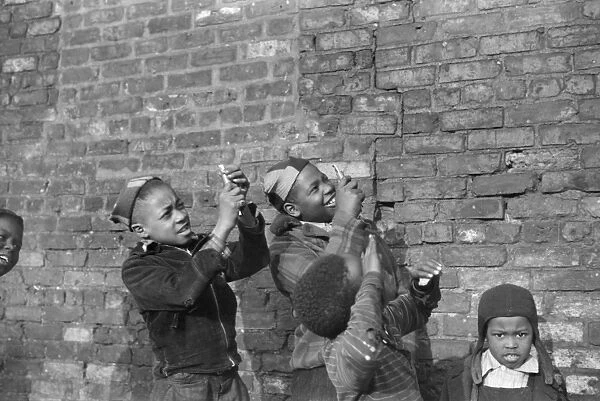 CHICAGO: CHILDREN, 1941. Boys playing and pretending that they are shooting machine