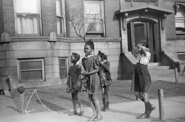 CHICAGO: CHILDREN, 1941. Children jumping rope outside of an apartment building