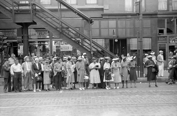 CHICAGO: COMMUTERS, 1940. Commuters waiting for a street car in Chicago, Illinois