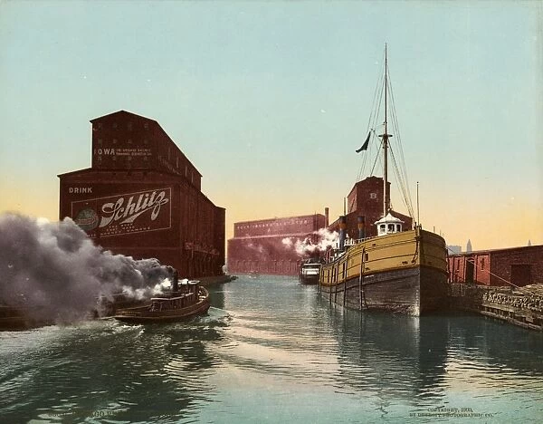 CHICAGO RIVER, c1900. Boats and elevators along the Chicago River in Chicago, Illinois