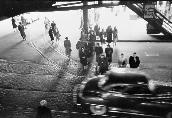 CHICAGO: STREET, 1949. A street scene below an El elevated train station in Chicago, Illinois