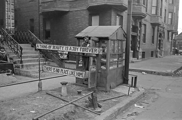 CHICAGO: VENDOR, 1941. A man with his newspaper stand and the sign reading A thing