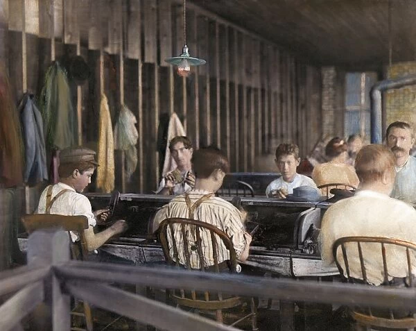 CHILD LABOR, c1900. Children working in an American cigar factory, c1900