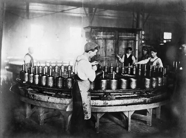 CHILD LABOR, c1902. Young boys pouring wax into molds in an American factory. Photograph