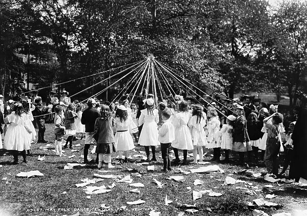 Children dancing around a Maypole in Central Park, New York City. Photograph, 1905