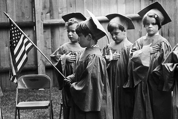 Children in a nursery school at South Weymouth, Massachusetts, pledging allegiance to the flag at the graduation ceremony, 1977