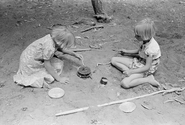 CHILDREN PLAYING, 1940. The Whinery children playing outside their home in Pie Town, New Mexico