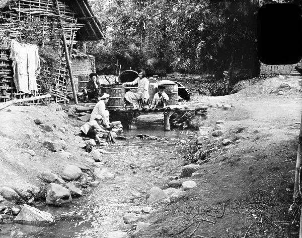 CHINA: CHEFANG, c1940. People washing their clothes in a stream, at the family s