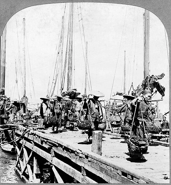 CHINA: COAL BARGES, c1902. Coolies unloading coal barges in Hong Kong, China. Stereograph