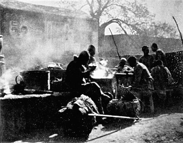 CHINA: COOLIES, c1912. Coolies taking their mid-day meal in Peking, China. Photograph