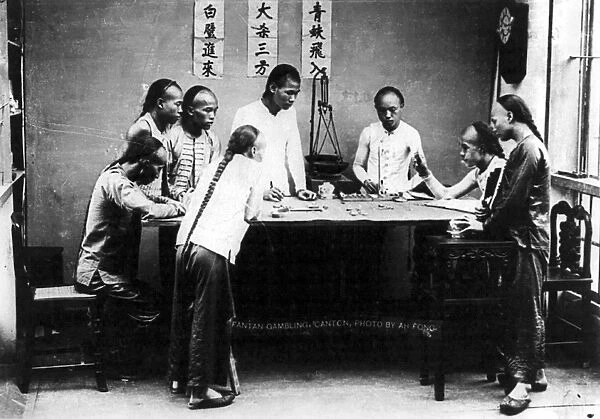 CHINA: GAMBLING. Men gambling on a game of fantan in Canton, China. Photographed by Ah Fong