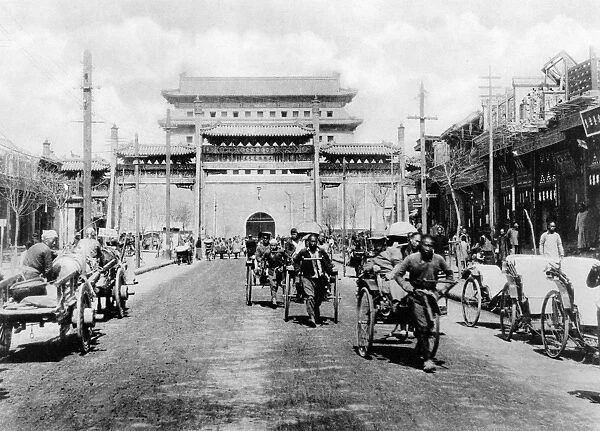 CHINA: PEKING, c1900. Rickshaws, carts, and people on Chien-men Street with the