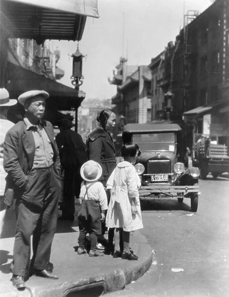 CHINESE IMMIGRANTS. A street scene in San Franciscos Chinatown. Photograph, c1920