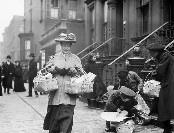 CHRISTMAS DINNER, 1908. Women carrying baskets containing Christmas dinner from the Salvation Army