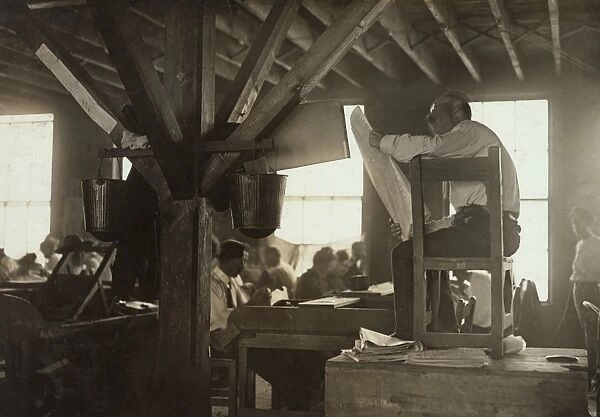 CIGAR FACTORY, 1909. A Reader in a cigar factory in Tampa, Florida. Photograph by Lewis Hine