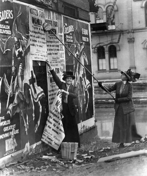 CINCINNATI: SUFFRAGETTES. Suffragettes Louise Hall and Susan Fitzgerald pasting signs for Votes For Women on a street in Cincinnati, Ohio, 1912